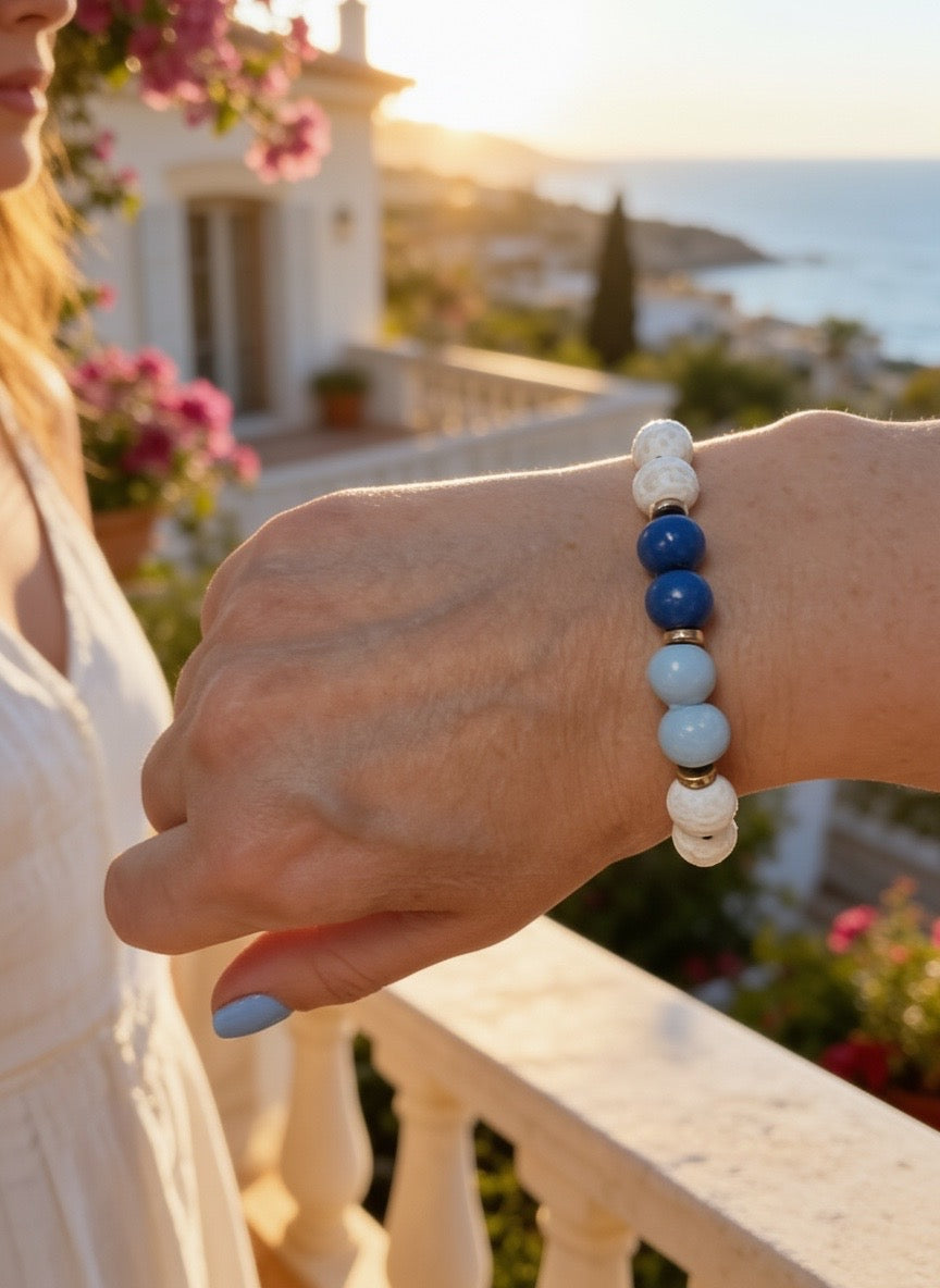 “Adjustable beaded bracelet with white, dark blue, and light blue beads worn on a wrist outdoors.”