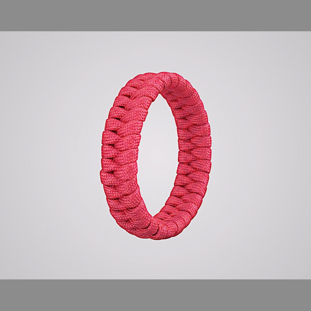Pink paracord survival bracelet shown close up.